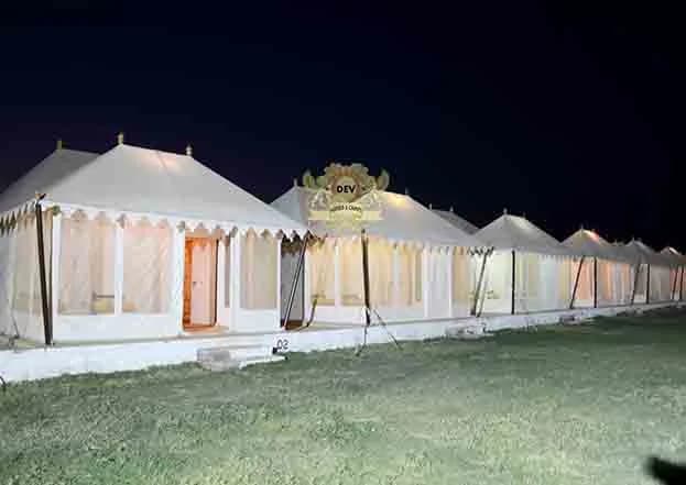 Row of Swiss tents lit up at dusk