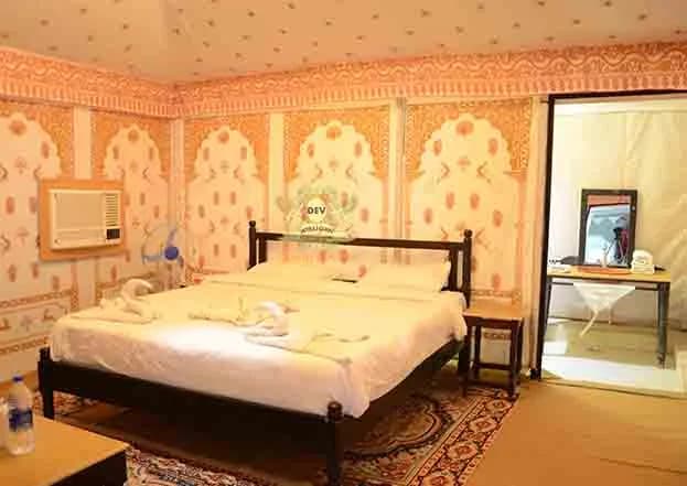 Luxury Swiss tent with a double bed and block-printed walls