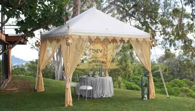 Cream pergola tent with draped curtains in a garden