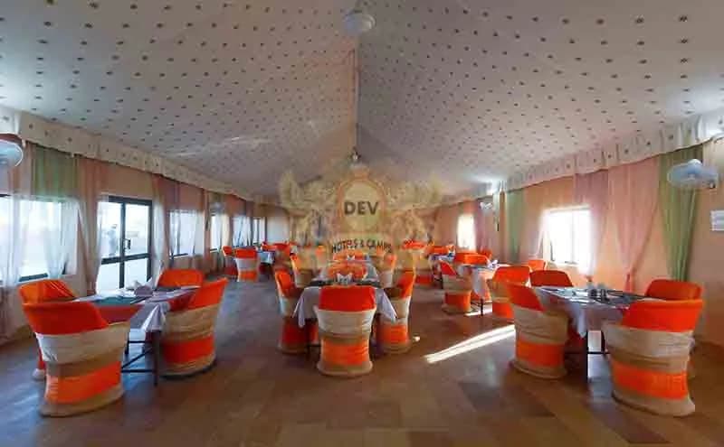 Restaurant dining hall with orange-covered chairs